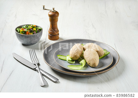 Semifinished frozen cepelinai. Potato dumplings stuffed with ground meat Semifinished frozen cepelinai. Potato dumplings stuffed with ground meat 83986582