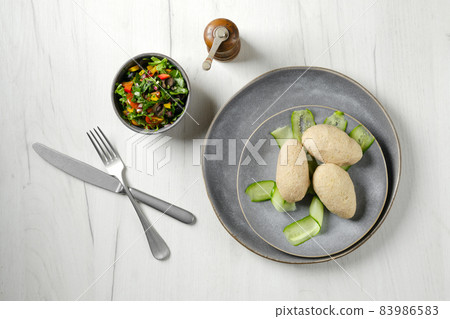 Top view of semifinished frozen cepelinai. Potato dumplings stuffed with ground meat Top view of semifinished frozen cepelinai. Potato dumplings stuffed with ground meat 83986583