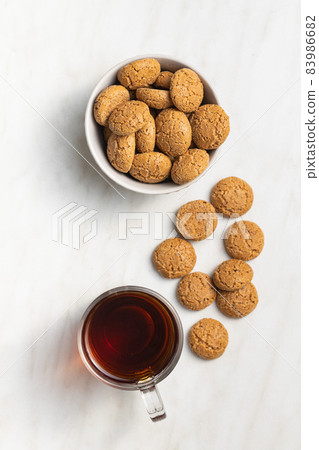 Amaretti biscuits. Sweet italian almond cookies and tea. 83986682