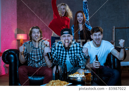 Group of friends watching TV match at home Group of friends watching TV match at home 83987022
