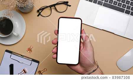Man hand holding mock up smart phone with blank screen. 83987108
