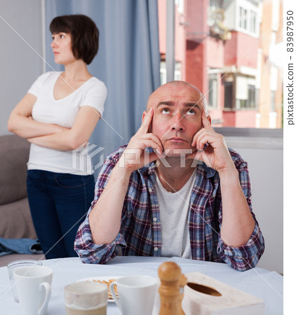 Domestic quarrel between offended husband and his wife at home Domestic quarrel between offended husband and his wife at home 83987950
