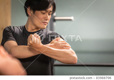Men looking at arm muscles 83988706
