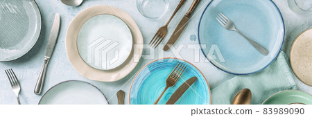 Modern dinnerware panorama with cutlery and various dishes, overhead shot Modern dinnerware panorama with cutlery and various dishes, overhead shot 83989090