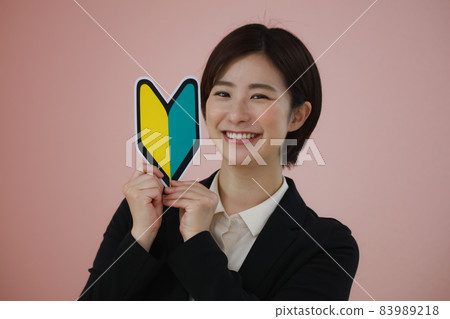 Female employee with a beginner mark 83989218