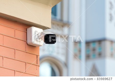Security cameras on modern building. Professional surveillance camera. CCTV on the wall with LED IR lights. Security system, technology concept. Video equipment for safety system area control outdoor. Security cameras on modern building. Professional surveillance camera. CCTV on the wall with LED IR lights. Security system, technology concept. Video equipment for safety system area control outdoor. 83989627