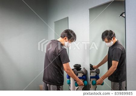 A man who trains his muscles in a sports gym (stoic) A man who trains his muscles in a sports gym (stoic) 83989985