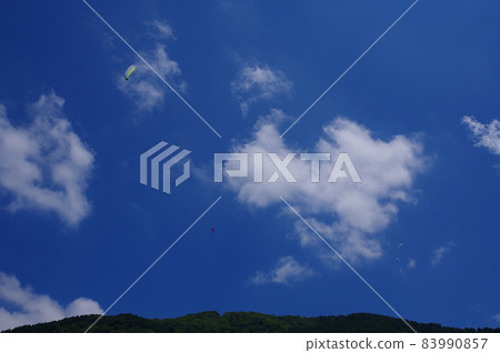 Paraglider flying over the Shishiku Highland Paraglider flying over the Shishiku Highland 83990857