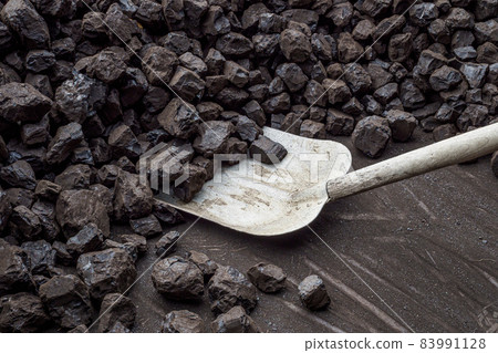 Shovel and a pile of brown coal for heating Shovel and a pile of brown coal for heating 83991128