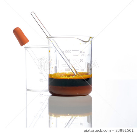 Closeup chemical ingredient on white laboratory table. Ferric Chloride Liquid with stirring rod in Beaker. Side View Closeup chemical ingredient on white laboratory table. Ferric Chloride Liquid with stirring rod in Beaker. Side View 83991501