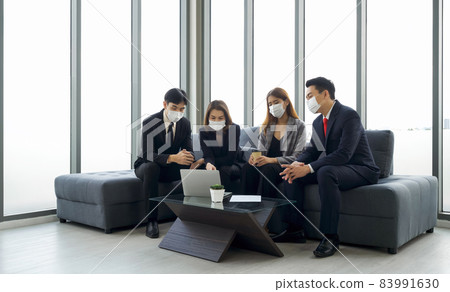 Group of business people in suit discuss about data on laptop computer. Everyone wears a mask. People corporate business team concept. Group of business people in suit discuss about data on laptop computer. Everyone wears a mask. People corporate business team concept. 83991630