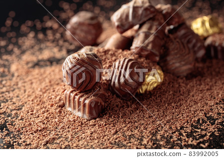 Chocolate candies sprinkled with chocolate chips. 83992005