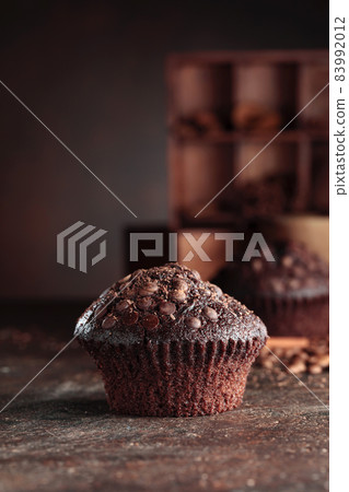 Chocolate muffins on a brown background. Chocolate muffins on a brown background. 83992012