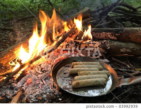 cooking on an open fire during bushcraft in the woods cooking on an open fire during bushcraft in the woods 83992939