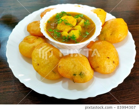 Jharkhand's famous snack Dhuska with potato curry Jharkhand's famous snack Dhuska with potato curry 83994307