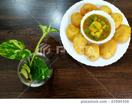 Jharkhand's famous snack Dhuska with potato curry Jharkhand's famous snack Dhuska with potato curry 83994308