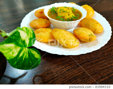 Jharkhand's famous snack Dhuska with potato curry 83994310