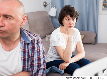 Unhappy mature man after quarrel, woman on background 83994432