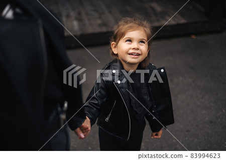 Cute little girl hodm mother's hand and smile. Happy childhood Cute little girl hodm mother's hand and smile. Happy childhood 83994623