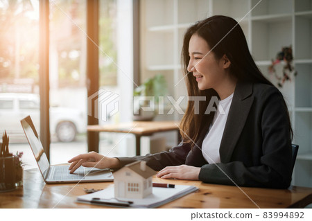 Business people gather in a corporate location to discuss research using paperwork. Concept of a group of businesses cooperating. 83994892