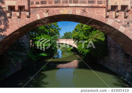 Old stone bridge in Nuremberg, Franconia, Germany. 83995410