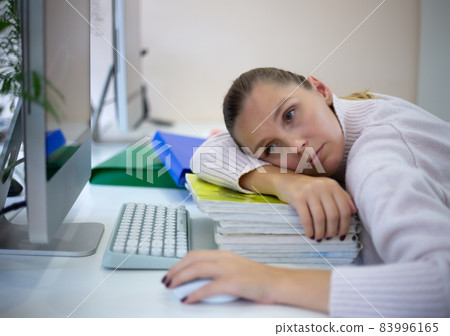young woman is sad at the workplace. office work concep young woman is sad at the workplace. office work concep 83996165