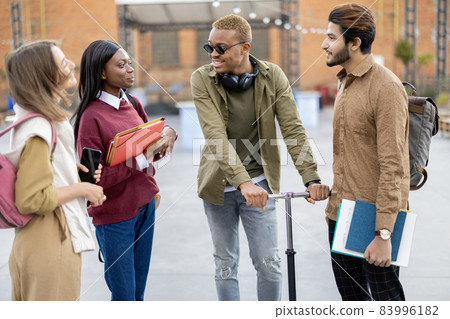 Students walk together at university campus Students walk together at university campus 83996182