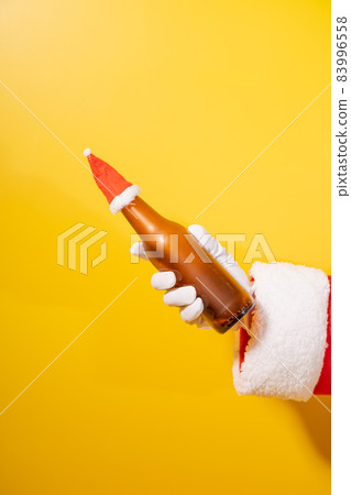 Santa Claus holding beer bottle with his hands 83996558