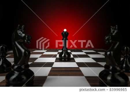 Chess board with figures on dark red background 83996985