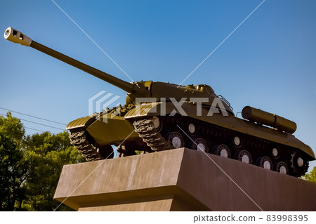 Military monument - an old tank on a pedestal. Symbol of Victory Day - military tank on a pedestal 83998395