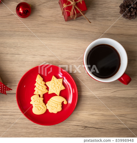 Merry Christmas with homemade cookies and coffee cup on wood table background. Xmas eve, party, holiday and happy New Year concept 83998948