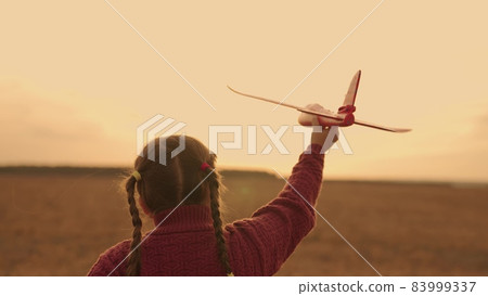 happy child runs sunset with toy airplane his hand, childhood dream flying, kid soars air fantasizing pallets, being an air transport pilot, flying wings up, girl running presenting wings light sun 83999337