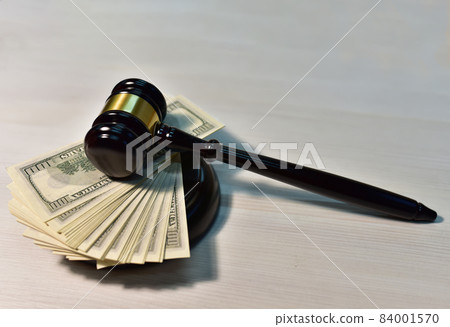Judge hammer and bundles of dollars. Justice in courtroom. Mallet of judge on law theme  84001570