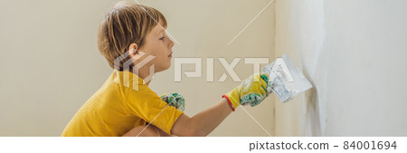 Man with his son makes repairs at home, he teaches children to plaster the walls with a spatula in his hands BANNER, LONG FORMAT Man with his son makes repairs at home, he teaches children to plaster the walls with a spatula in his hands BANNER, LONG FORMAT 84001694