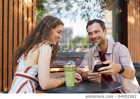 Smiling Couple in Outdoor Cafe 84002882