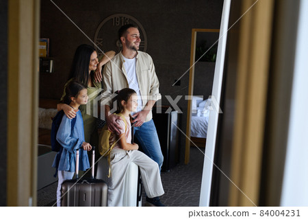 Happy young family with two children enetring room at luxury hotel, summer holiday. Happy young family with two children enetring room at luxury hotel, summer holiday. 84004231