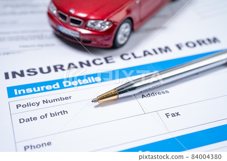 Pen with red car on Insurance  claim accident car form, Car loan, insurance and leasing time concepts. 84004380