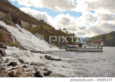 Ship standing next to fjord Waterfall Langfossand, Geiranger fjord, Norway landscape view - summer and nature 84006147