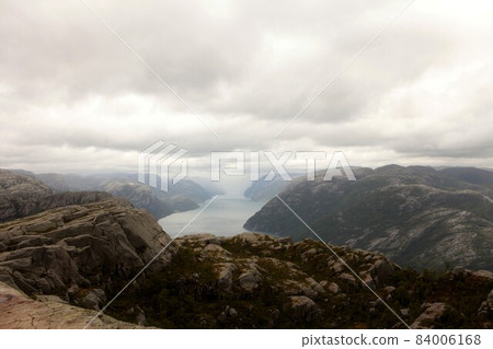 View from the Cliff Preikestolen in fjord Lysefjord - Norway - nature and travel background. Vacation concept. Granite rocks and mountains View from the Cliff Preikestolen in fjord Lysefjord - Norway - nature and travel background. Vacation concept. Granite rocks and mountains 84006168