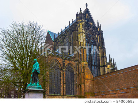 The tower of the Dom cathedral above a row of historical houses of Utrecht, Holland The tower of the Dom cathedral above a row of historical houses of Utrecht, Holland 84006692