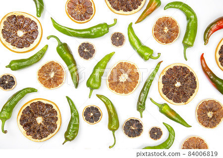 hot green peppers and dried citrus fruit on a white background. grocery organic flatley hot green peppers and dried citrus fruit on a white background. grocery organic flatley 84006819