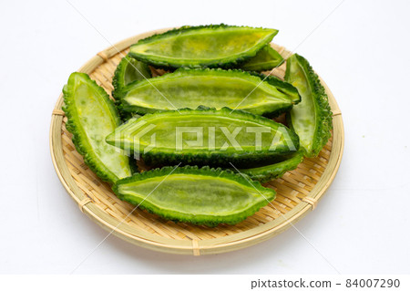 Bitter gourd in bamboo basket on white background. 84007290