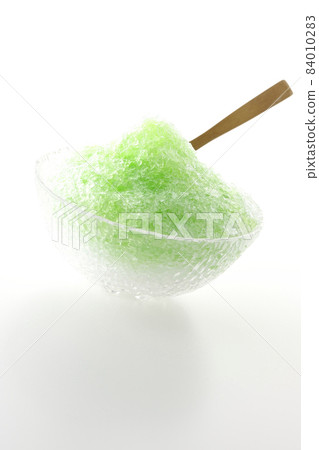 Shooting shaved ice with melon-flavored syrup on a white background Shooting shaved ice with melon-flavored syrup on a white background 84010283