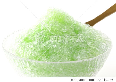 Shooting shaved ice with melon-flavored syrup on a white background Shooting shaved ice with melon-flavored syrup on a white background 84010286