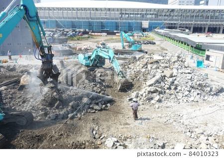 Building demolition work site with large heavy machinery demolished 84010323