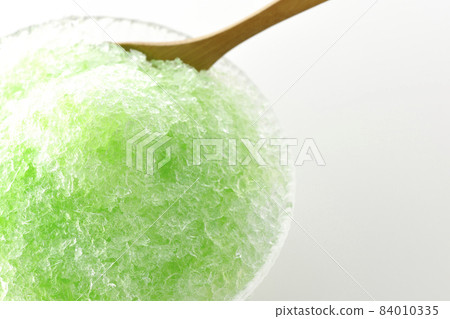 A bird's-eye view of shaved ice with melon-flavored syrup on a white background A bird's-eye view of shaved ice with melon-flavored syrup on a white background 84010335