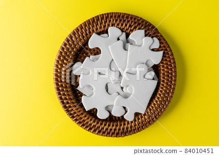 White jigsaw puzzle in container White jigsaw puzzle in container 84010451