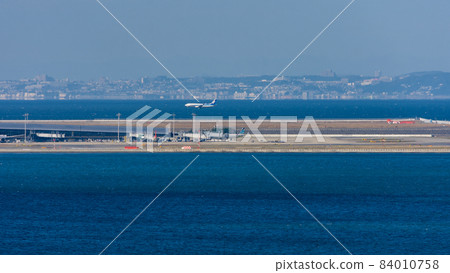 ANA plane landing at the Kansai International Airport in Osaka, Japan 84010758