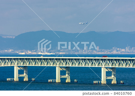 ANA plane flying over the Sky Gate Bridge, landing at the Kansai Airport, Osaka 84010760