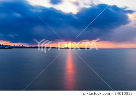 Sunset over the ocean in Osaka Bay with dramatic sky and clouds 84010832